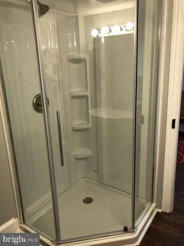 a bathroom with a glass door shower