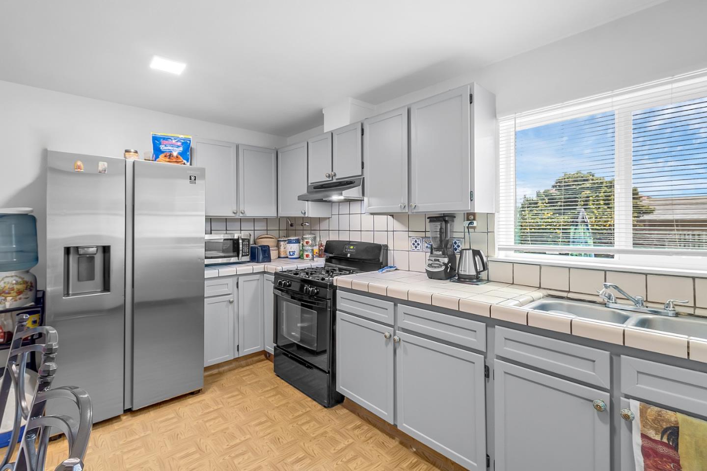 25540 Payson Street Chualar, CA 93925 - Photo 18 of 31 a kitchen with stainless steel appliances granite countertop a sink a stove a refrigerator a window and cabinets