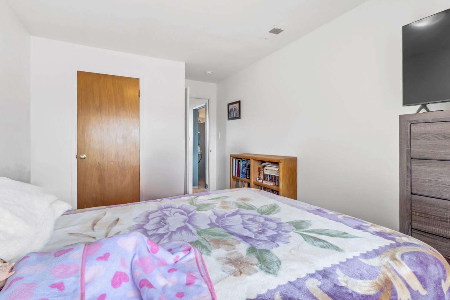 25540 Payson Street Chualar, CA 93925 - Photo 21 of 31 a bedroom with a bed and a flat screen tv