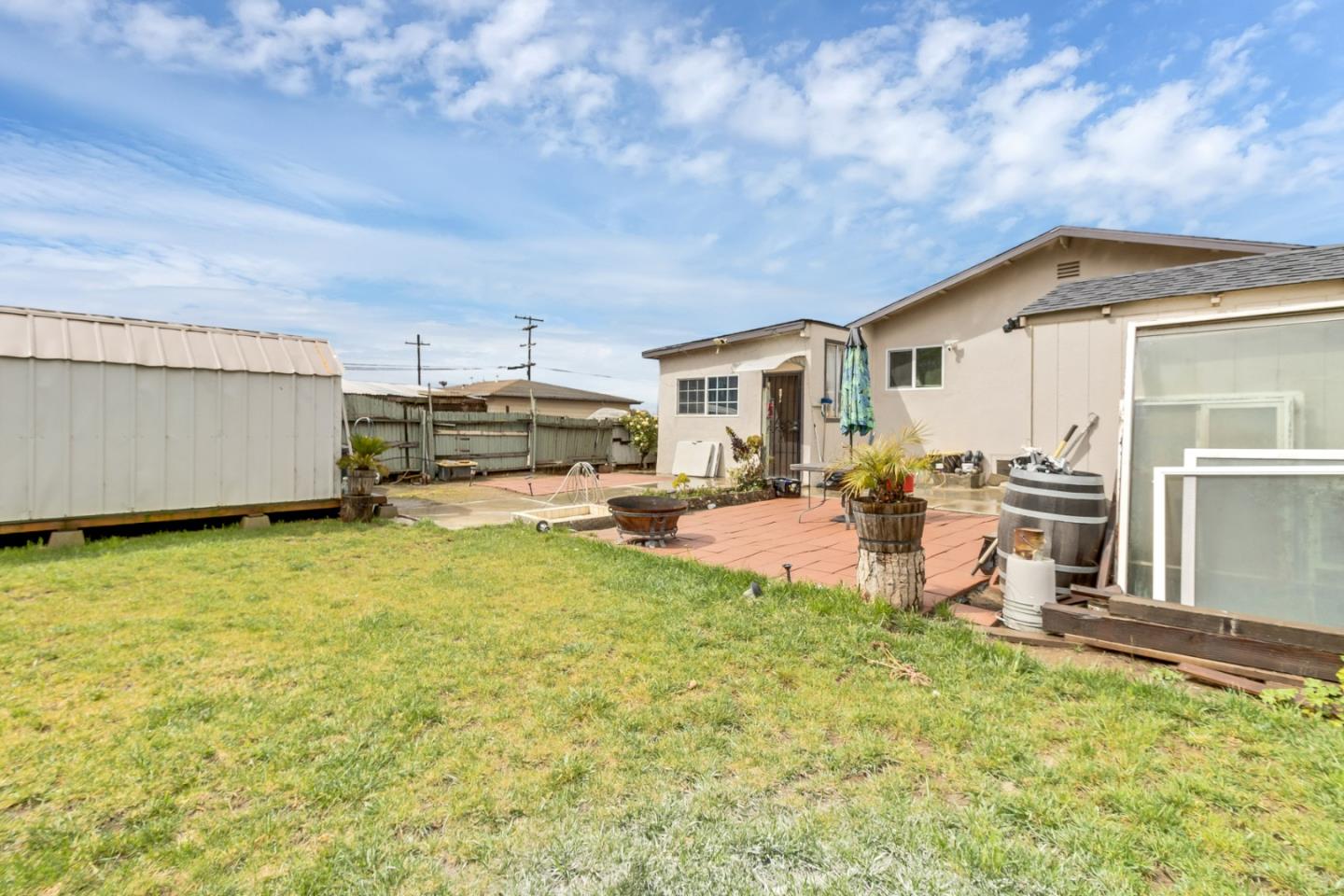 25540 Payson Street Chualar, CA 93925 - Photo 26 of 31 a view of a backyard with table and chairs under an umbrella