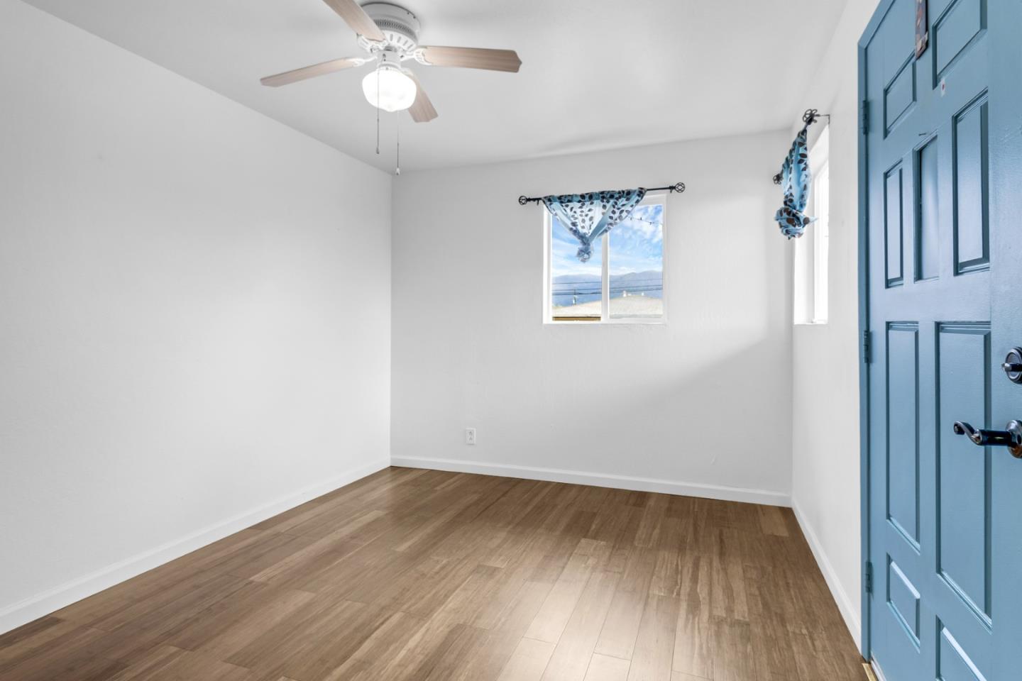 25540 Payson Street Chualar, CA 93925 - Photo 6 of 31 wooden floor in an empty room with a window