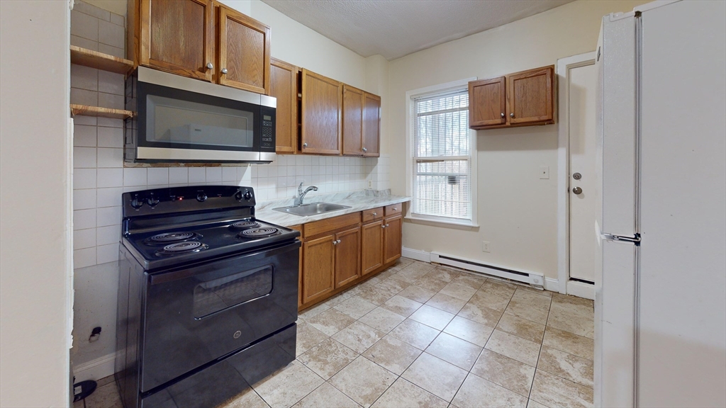 a kitchen with stainless steel appliances granite countertop a stove and a microwave