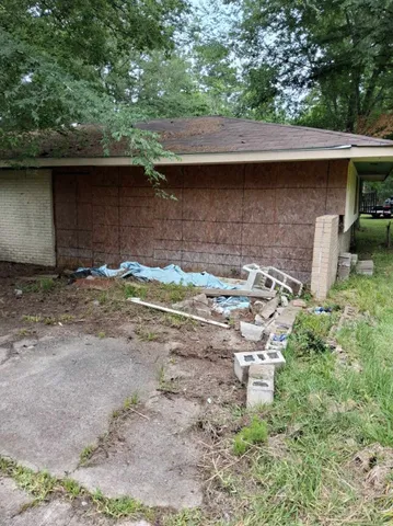 a view of a house with a yard and a garage