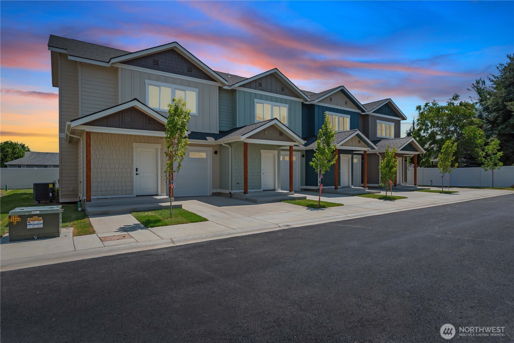 1030 Finch Lane, Unit H1 Wenatchee, WA 98801 - Photo 1 of 30 a front view of a house with a yard and garage