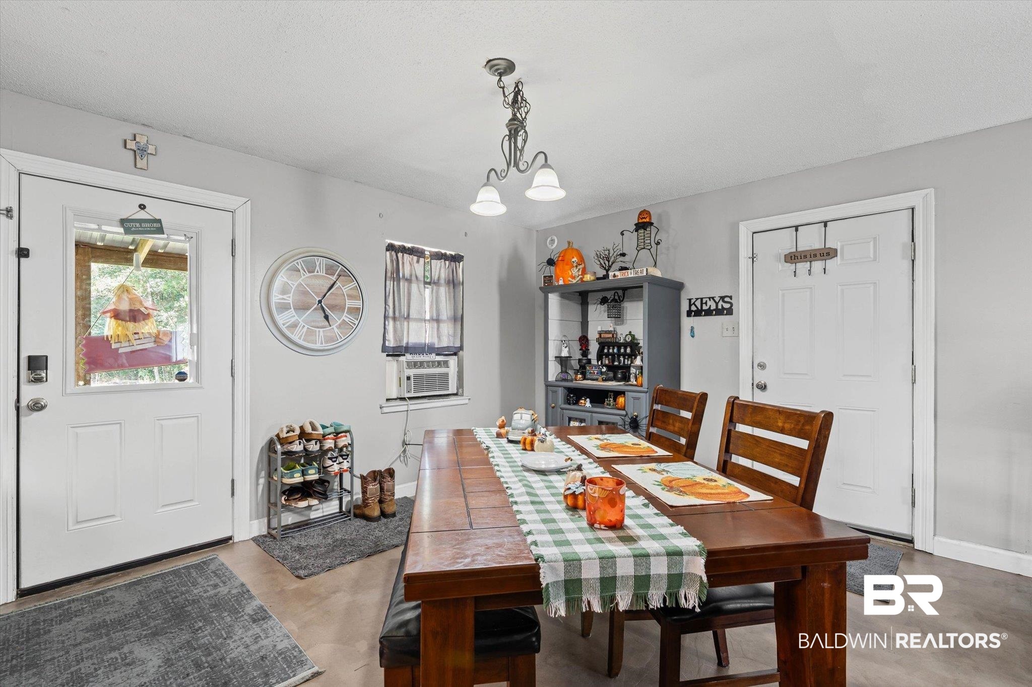 11440 Diffee Road Grand Bay, AL 36541 - Photo 11 of 22 Dining space featuring cooling unit, concrete floors, and suspended lighting