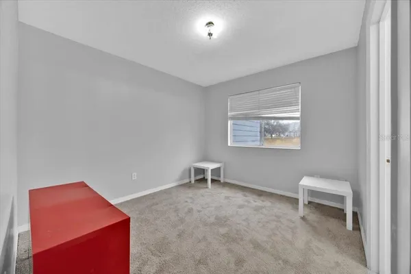 a hallway with table and a chair