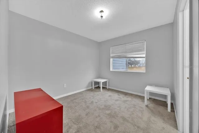 a hallway with table and a chair