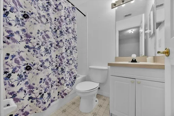 a bathroom with a sink toilet and a mirror