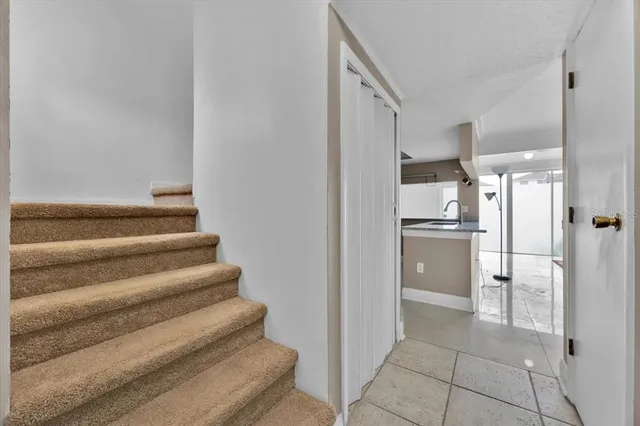 a view of a kitchen with refrigerator and empty shelves