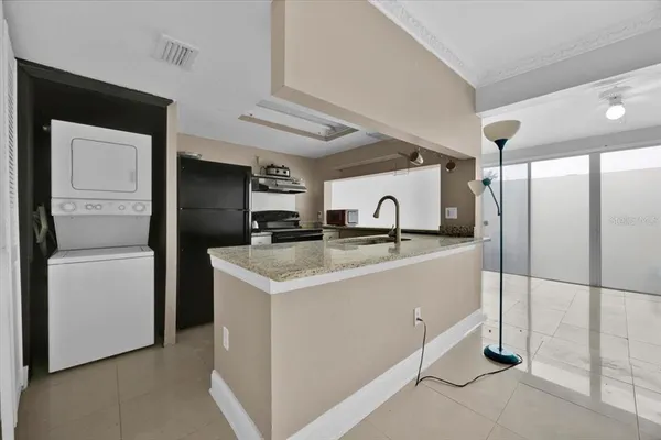 a kitchen with a refrigerator sink and cabinets