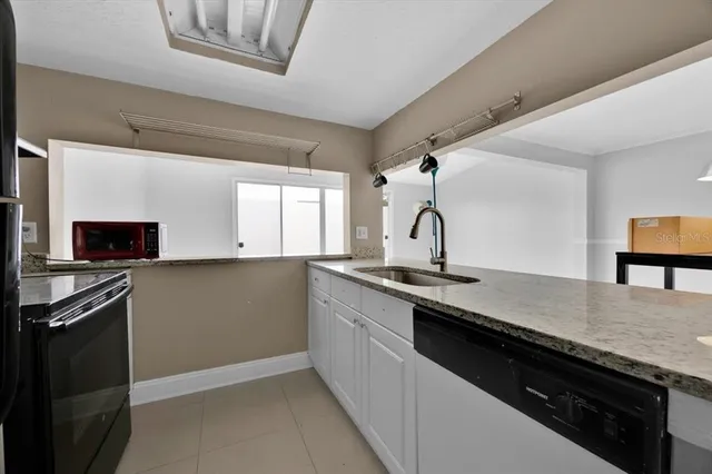 a kitchen with a sink and a stove top oven