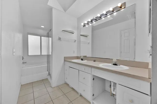 a bathroom with a tub sink and mirror