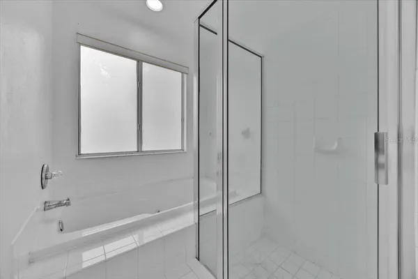 a bathroom with a bathtub and a shower