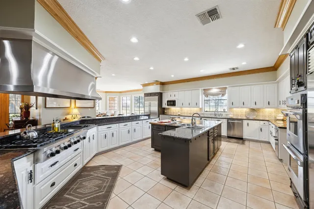 a living room with furniture kitchen view and a flat screen tv