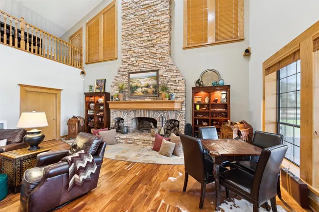 a living room with furniture a flat screen tv and a window