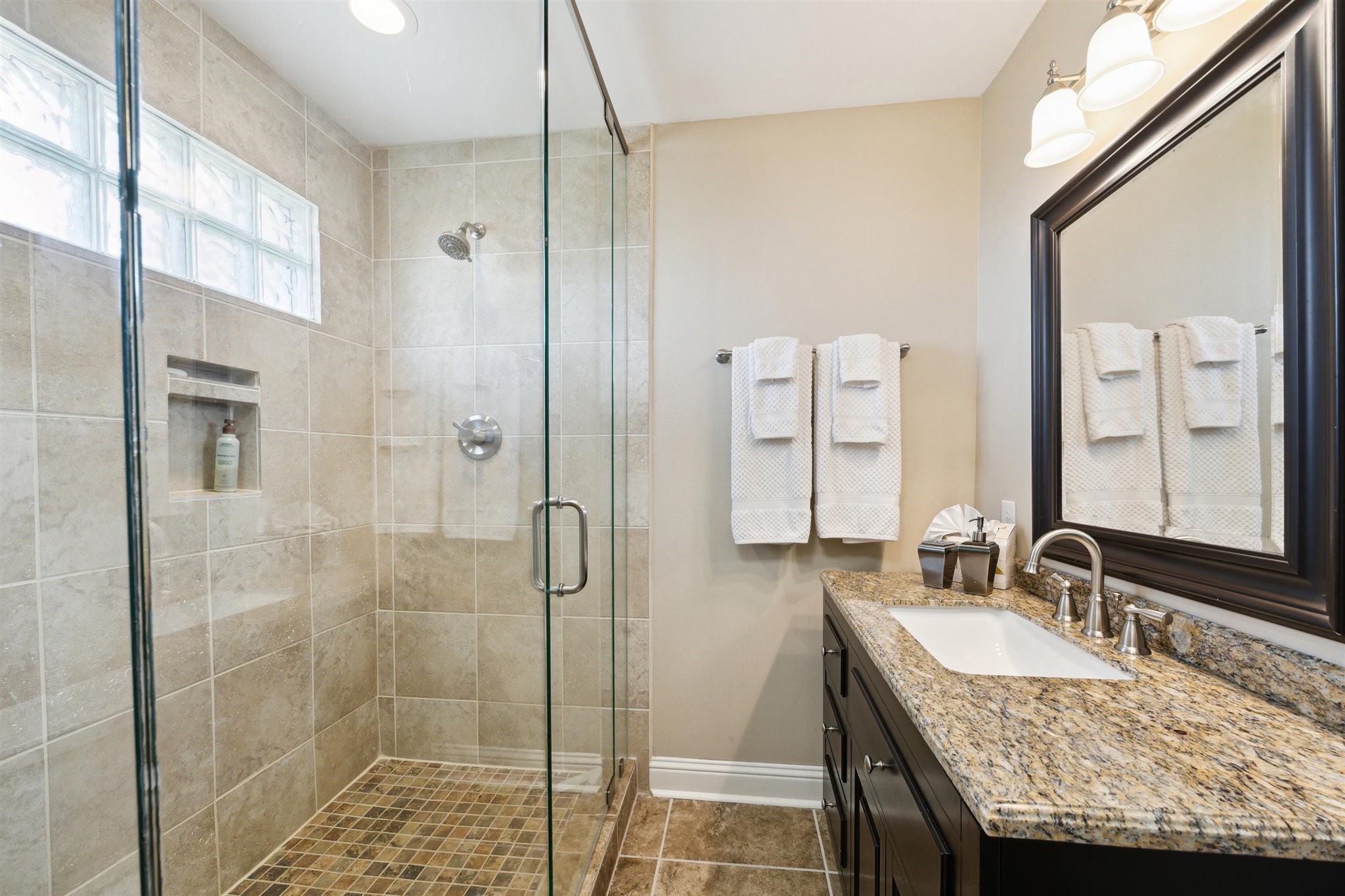 1224 Haines Road Sheridan, TX 77475 - Photo 37 of 49 a bathroom with a granite countertop sink a mirror and shower