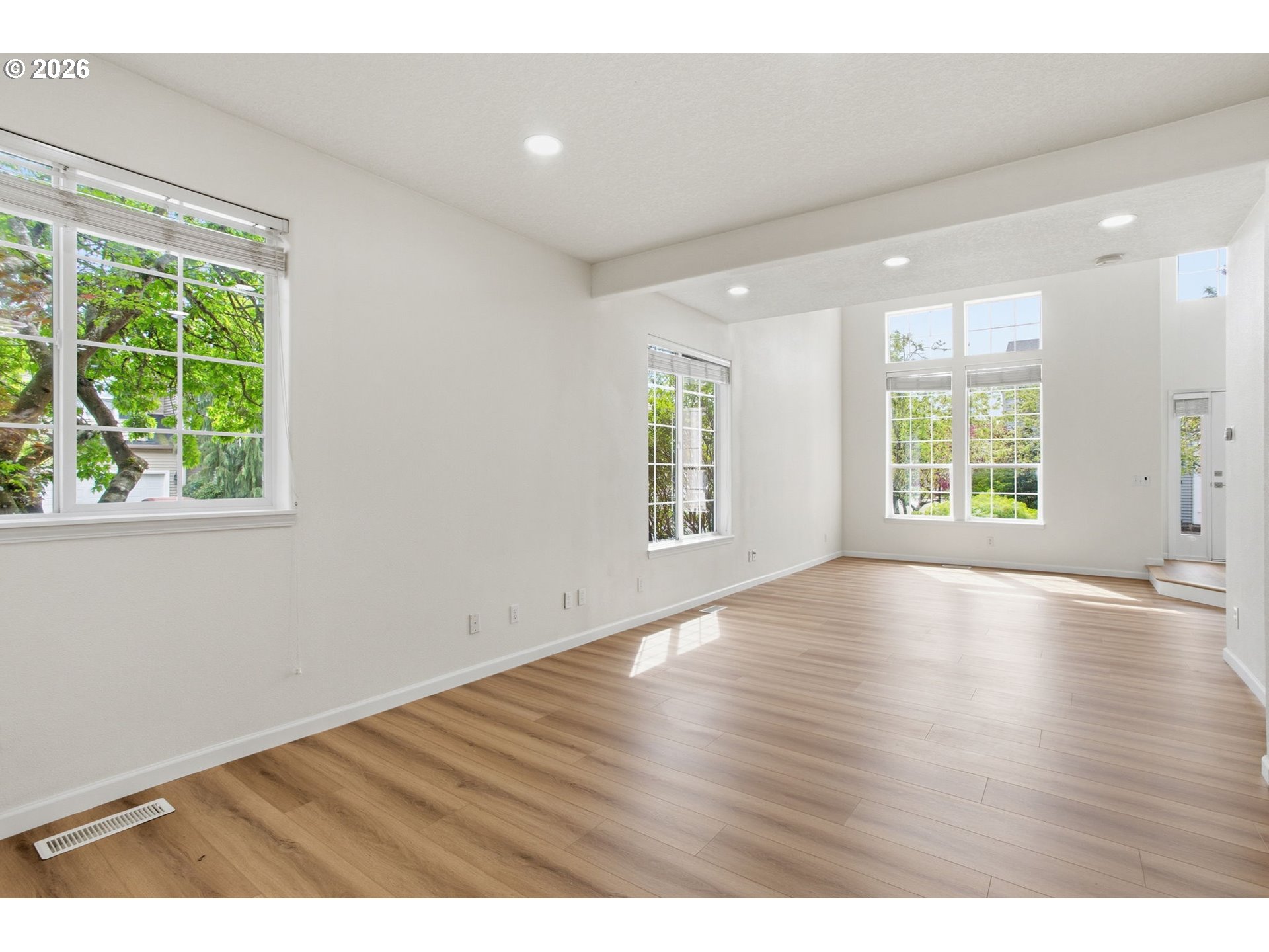 8911 Southwest Gravenstein Lane Tigard, OR 97224 - Photo 7 of 33 an empty room with wooden floor and windows