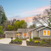 a backyard of a house with table and chairs