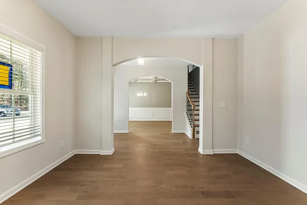 an empty room with windows and entrance