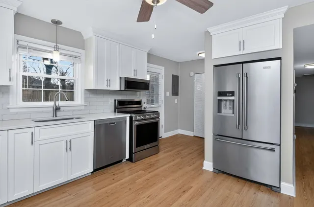 a kitchen with stainless steel appliances a refrigerator sink and microwave