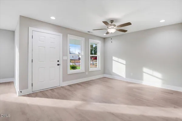 a living room with furniture a flat screen tv and a potted plant