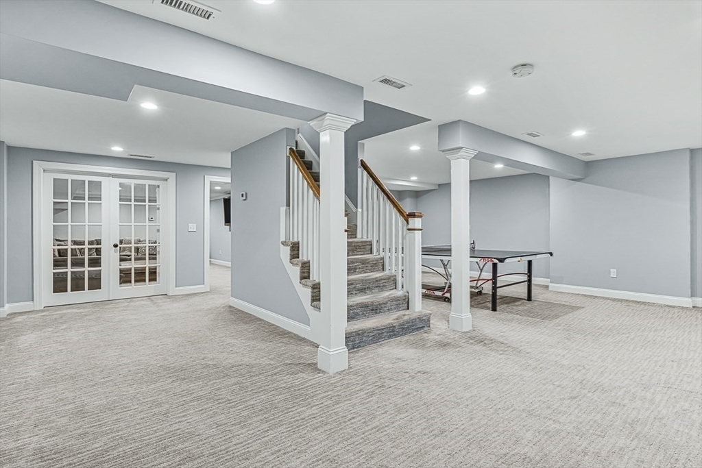 56 Lantern Lane Needham, MA 02492 - Photo 31 of 42 a view of an empty room with stairs and furniture