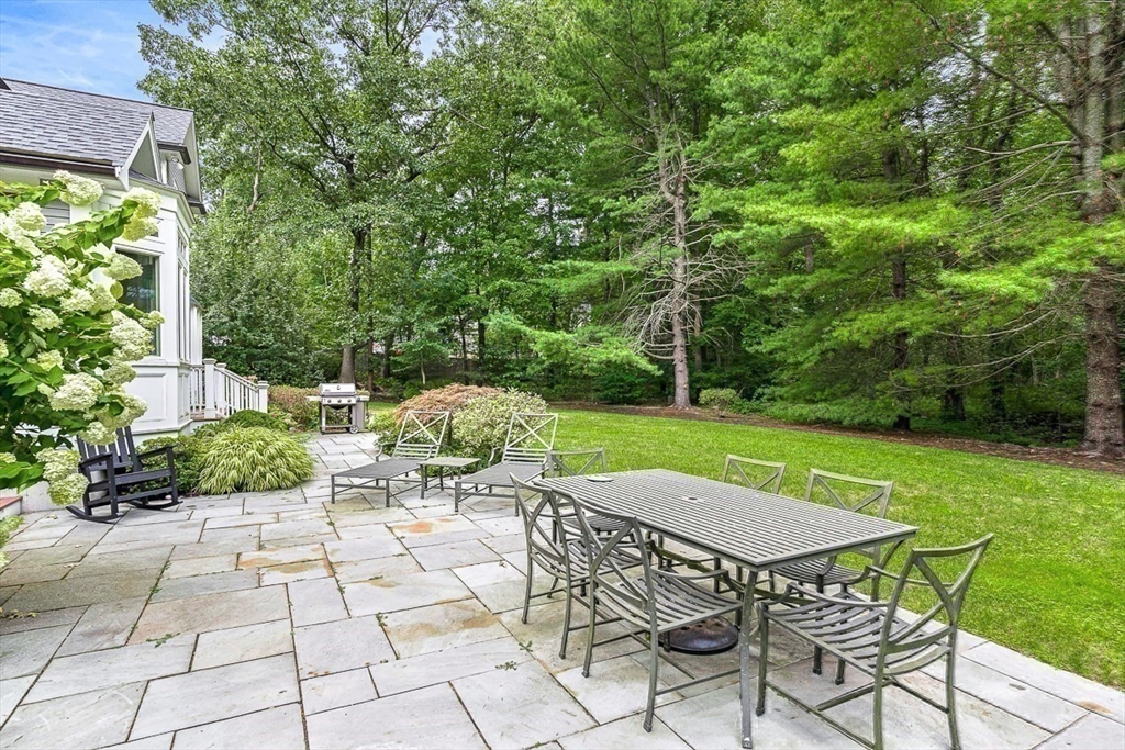 56 Lantern Lane Needham, MA 02492 - Photo 38 of 42 a view of a patio with table and chairs potted plants with large trees