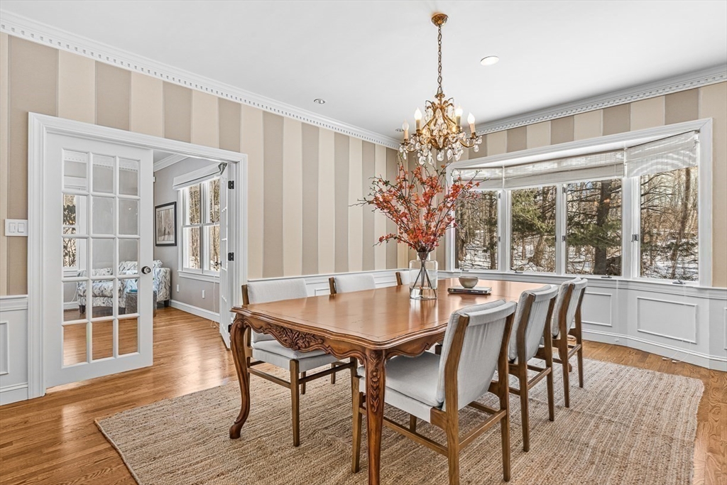 56 Lantern Lane Needham, MA 02492 - Photo 7 of 42 a dining room with furniture wooden floor a chandelier and a rug