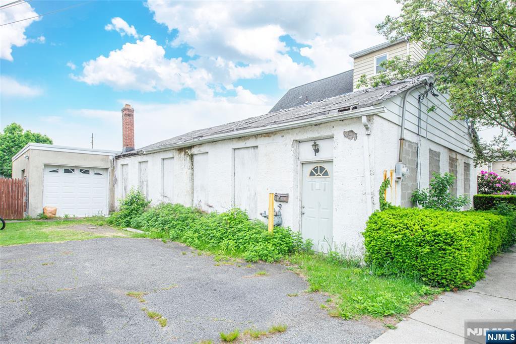 84 Locust Avenue Wallington, NJ 07057 - Photo 1 of 5 a front view of a house with garden