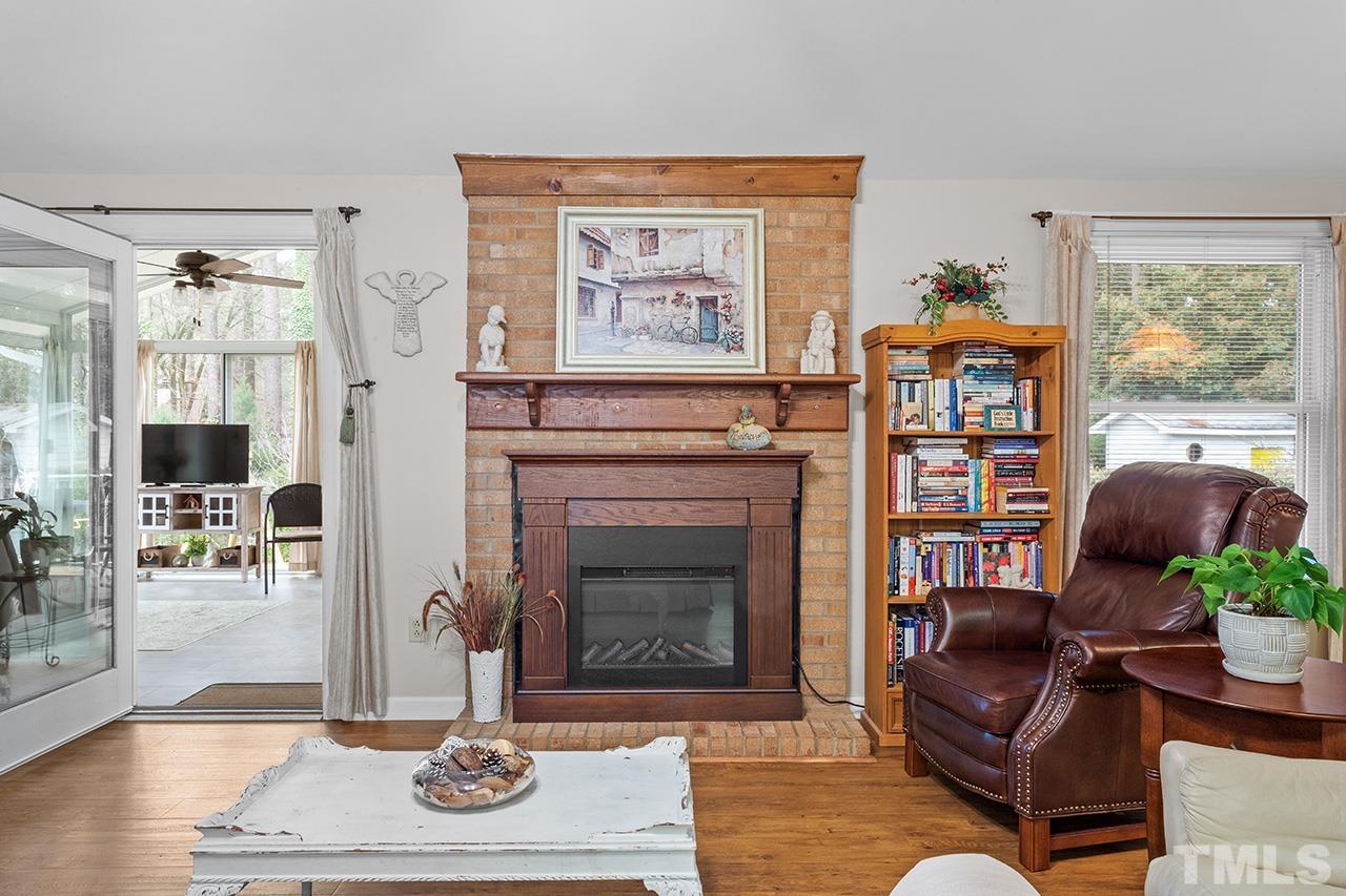 6921 Chamonix Place Raleigh, NC 27613 - Photo 12 of 30 a living room with furniture and a fireplace