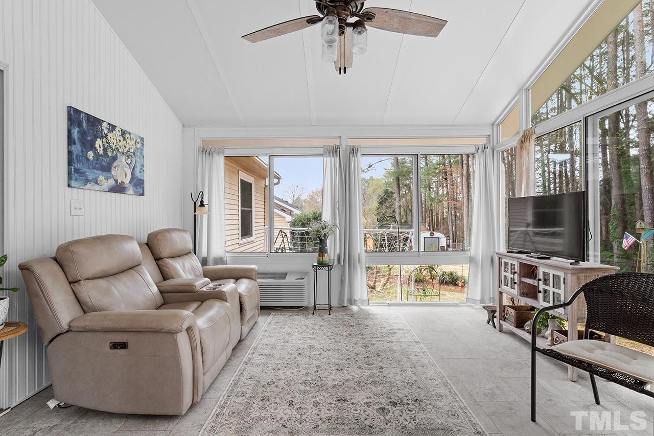 6921 Chamonix Place Raleigh, NC 27613 - Photo 14 of 30 a living room with furniture and a flat screen tv