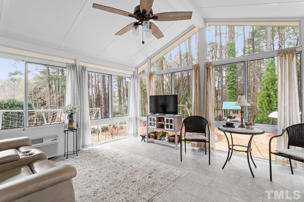 6921 Chamonix Place Raleigh, NC 27613 - Photo 15 of 30 a living room with furniture tv and large windows