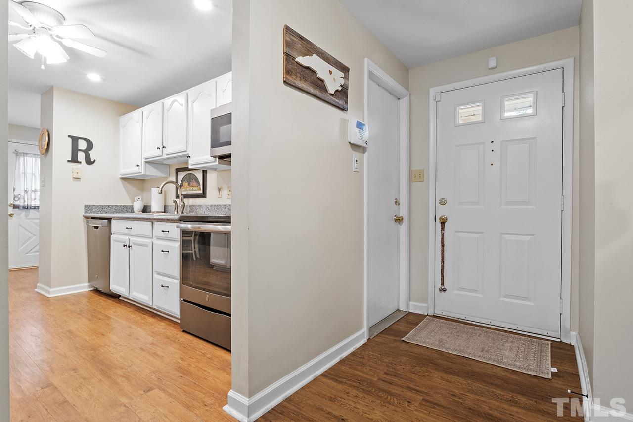 6921 Chamonix Place Raleigh, NC 27613 - Photo 2 of 30 a view of kitchen with stainless steel appliances cabinets and wooden floor