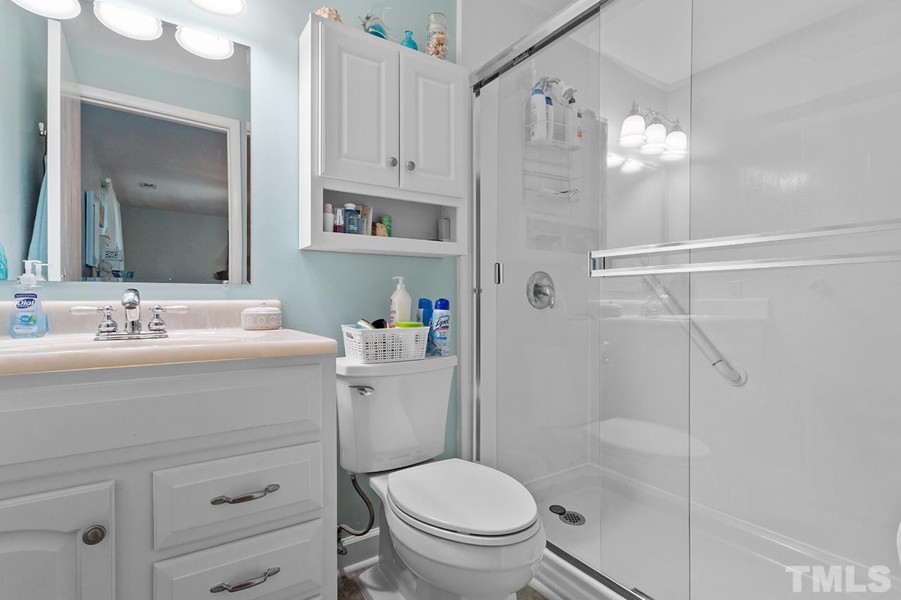 6921 Chamonix Place Raleigh, NC 27613 - Photo 23 of 30 a bathroom with a sink a toilet and shower