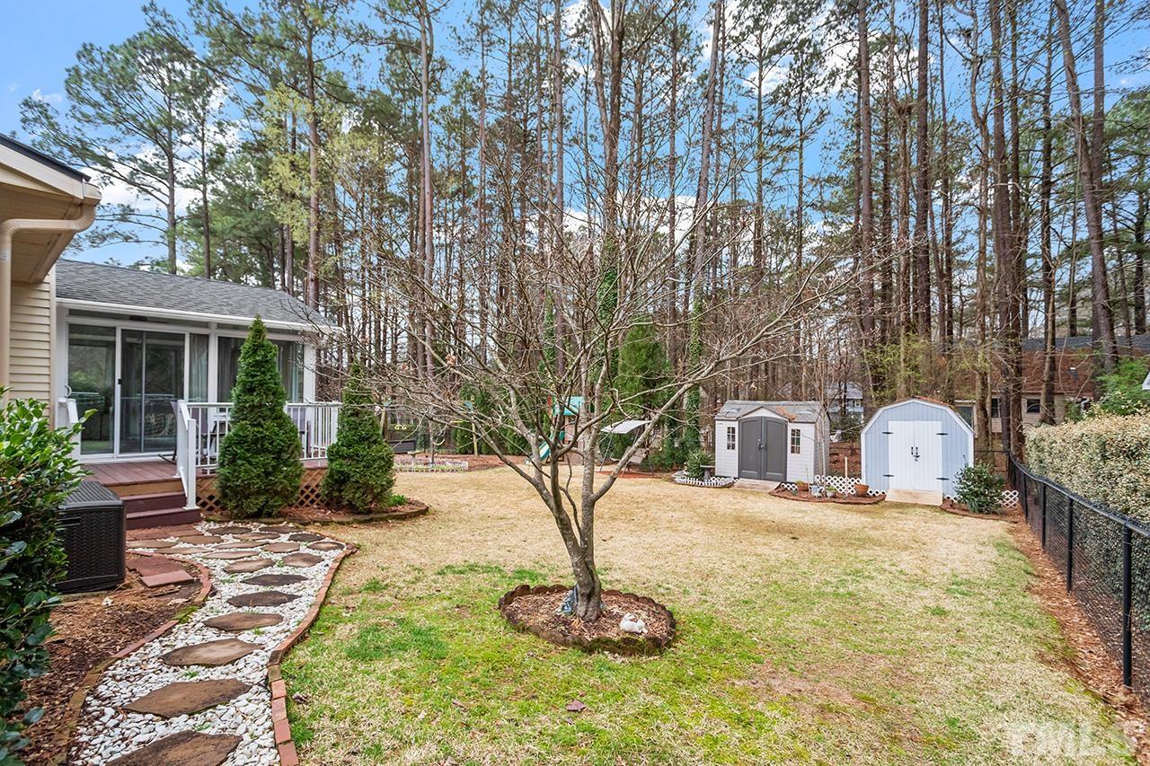 6921 Chamonix Place Raleigh, NC 27613 - Photo 26 of 30 a view of a house with backyard and sitting area