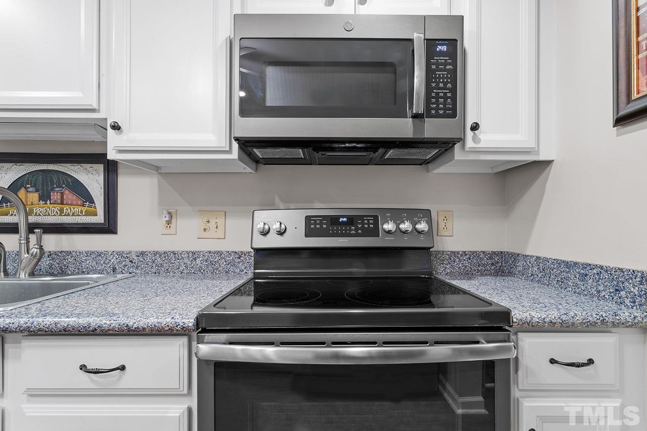 6921 Chamonix Place Raleigh, NC 27613 - Photo 5 of 30 a stove top oven sitting inside of a kitchen