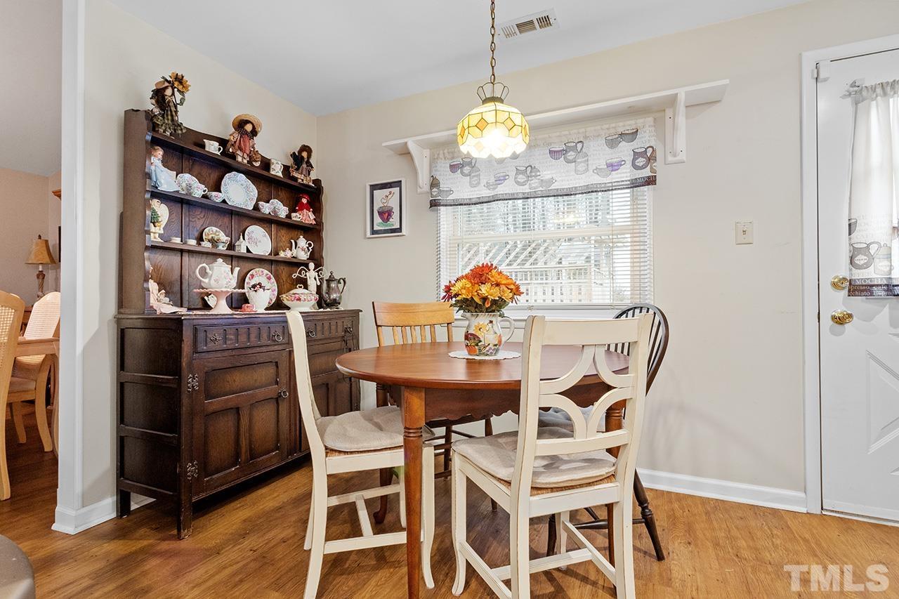 6921 Chamonix Place Raleigh, NC 27613 - Photo 8 of 30 a view of a dining room with furniture and wooden floor