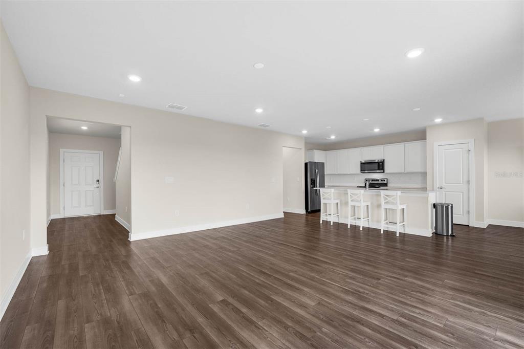 7367 Catania Loop Clermont, FL 34714 - Photo 11 of 58 a view of kitchen with kitchen island wooden floor appliances and cabinets