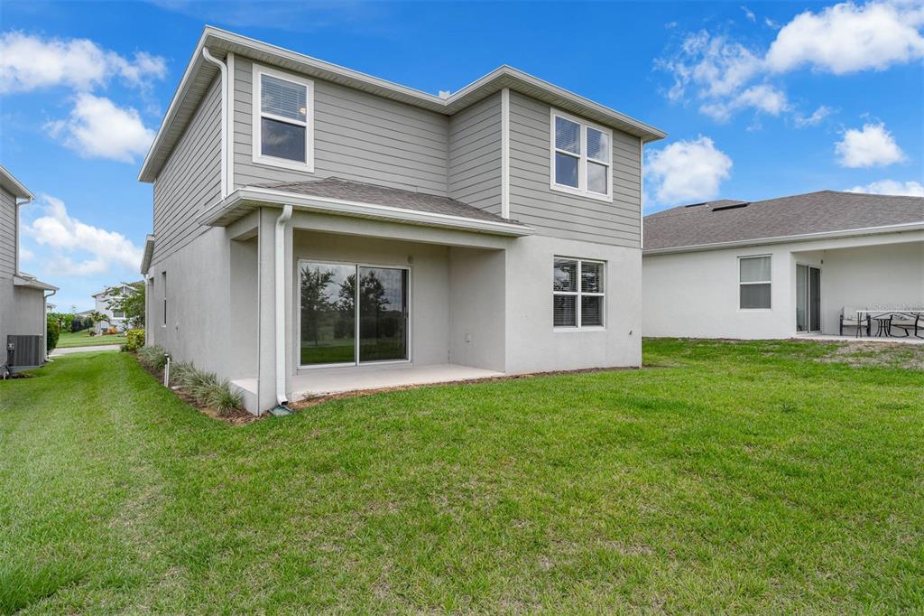 7367 Catania Loop Clermont, FL 34714 - Photo 13 of 58 a front view of a house with a garden