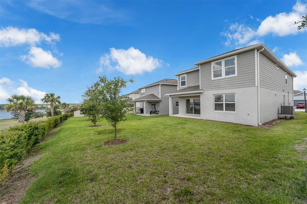 7367 Catania Loop Clermont, FL 34714 - Photo 15 of 58 a view of a house with backyard and garden