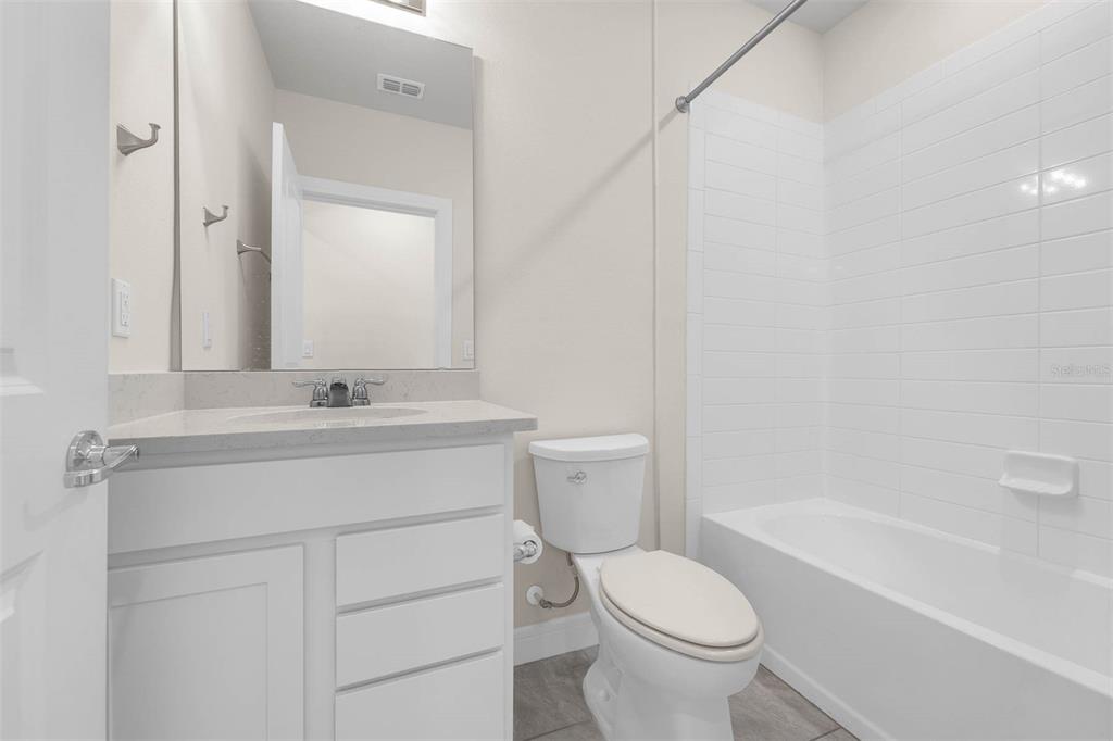 7367 Catania Loop Clermont, FL 34714 - Photo 21 of 58 a bathroom with a sink toilet and a mirror