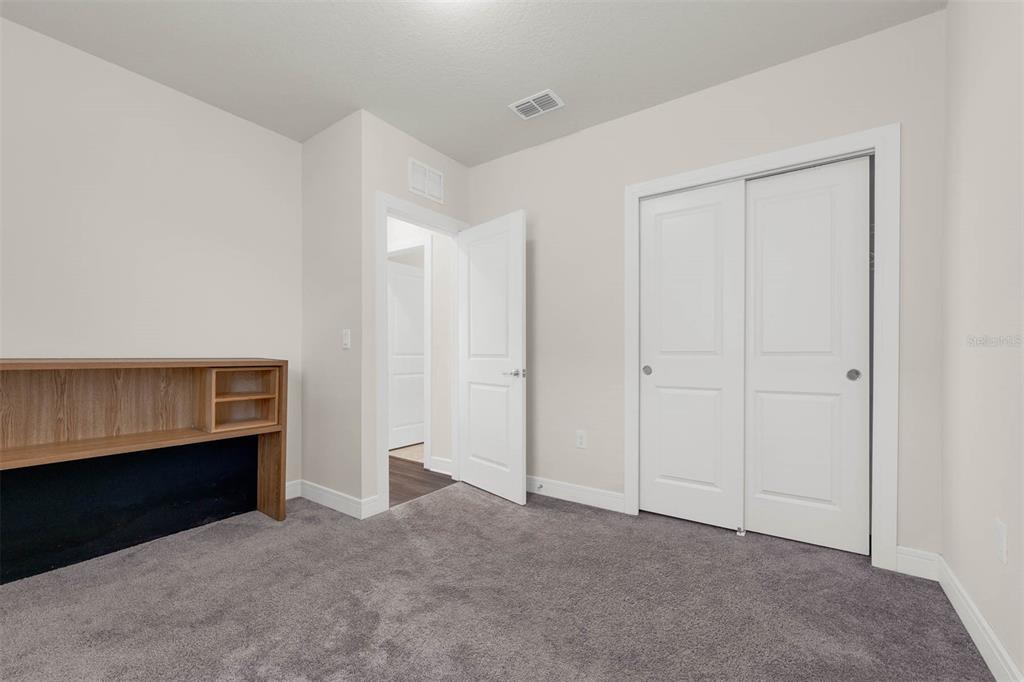 7367 Catania Loop Clermont, FL 34714 - Photo 22 of 58 a view of an empty room with workspace and closet