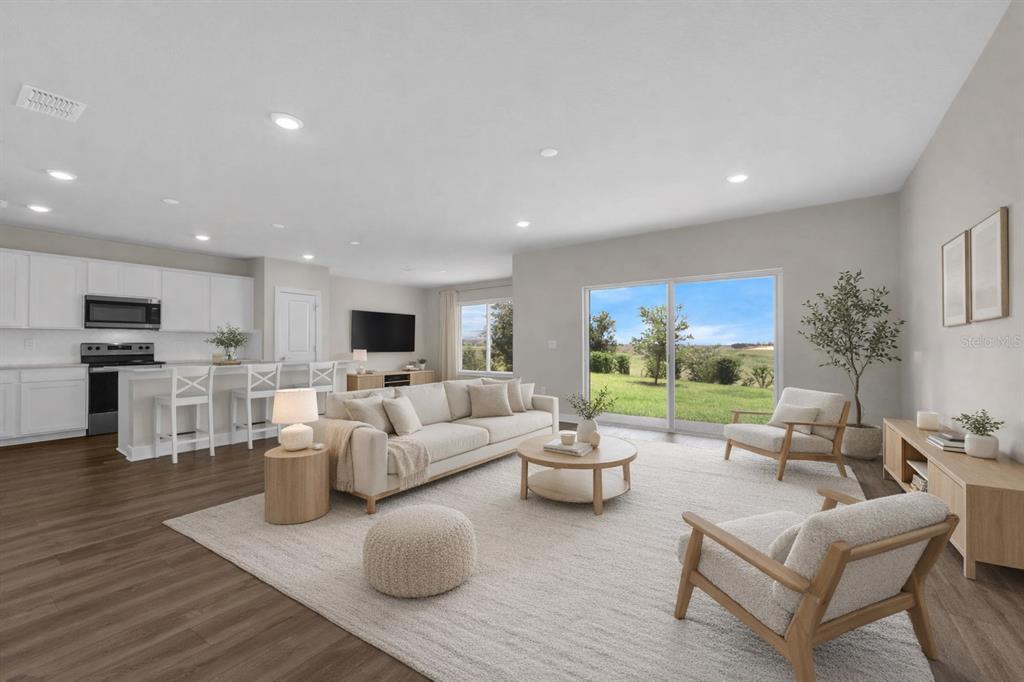 7367 Catania Loop Clermont, FL 34714 - Photo 3 of 58 a living room with fireplace furniture and a flat screen tv