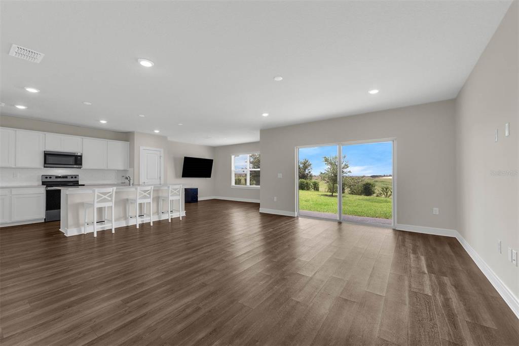 7367 Catania Loop Clermont, FL 34714 - Photo 4 of 58 a view of kitchen with furniture and wooden floor