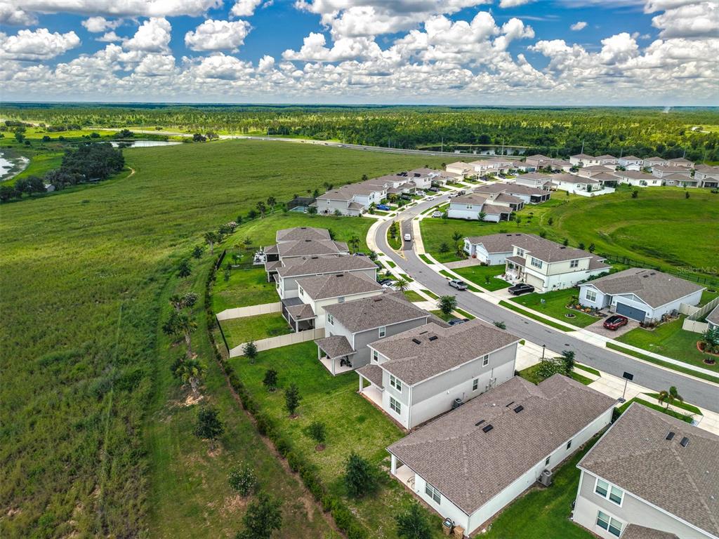 7367 Catania Loop Clermont, FL 34714 - Photo 51 of 58 an aerial view of a house with a garden