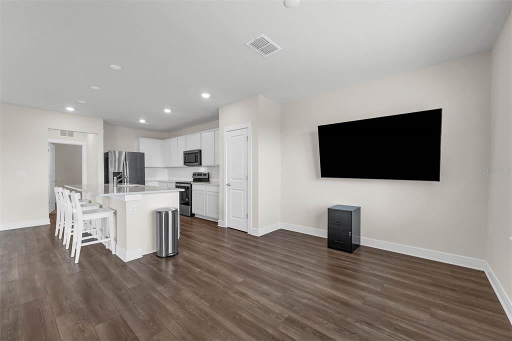 7367 Catania Loop Clermont, FL 34714 - Photo 9 of 58 a view of kitchen with microwave stove refrigerator and chairs