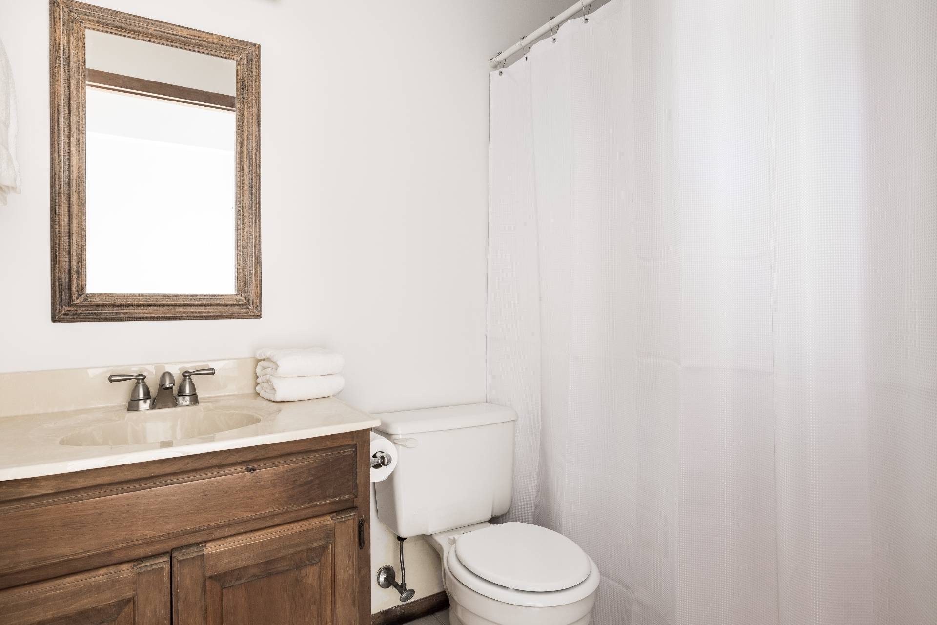 3564 Noyack Road Sag Harbor, NY 11963 - Photo 6 of 10 a bathroom with a sink a toilet and a mirror