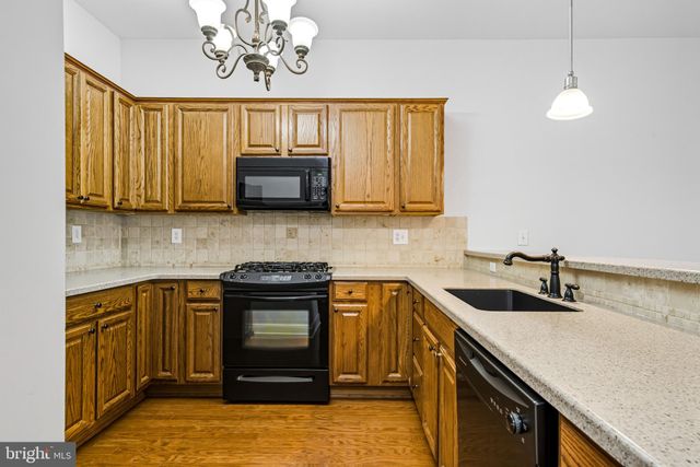 a kitchen with a sink stove and microwave