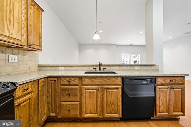 a kitchen with stainless steel appliances granite countertop a sink and cabinets