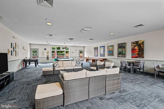 a view of a patio with table and chairs with wooden floor and fence